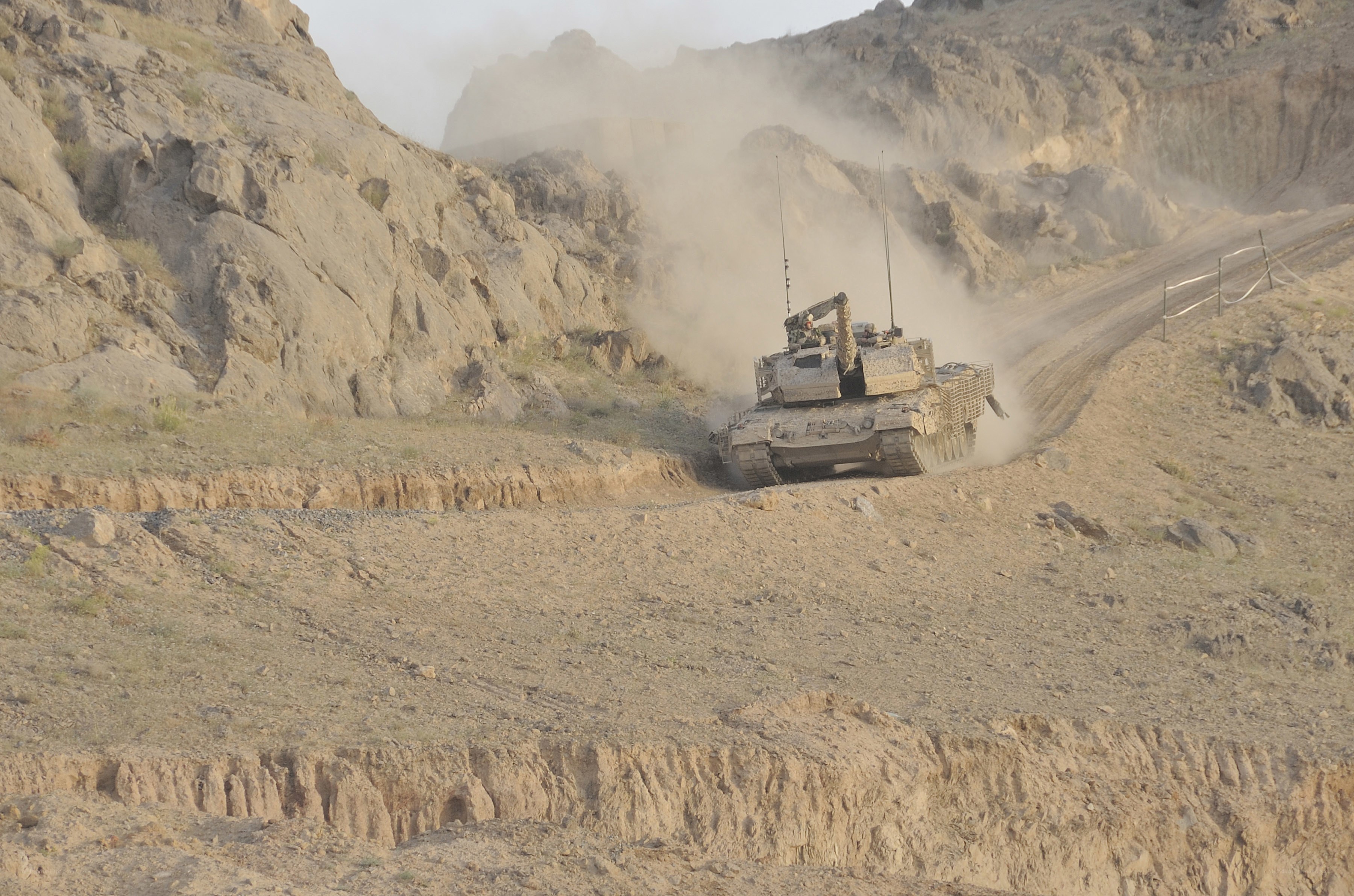 tank on dusty mountain road