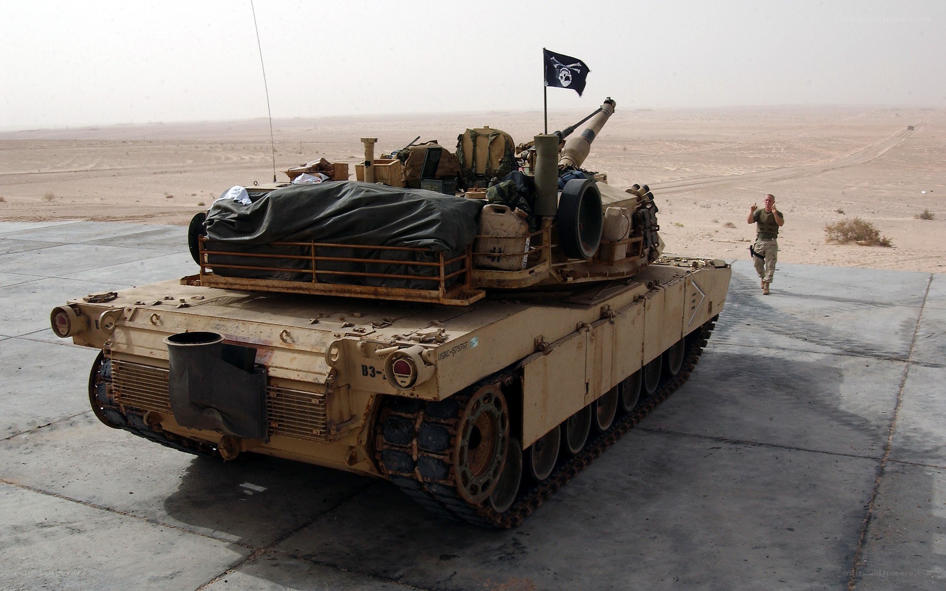 Tank with black flag in desert