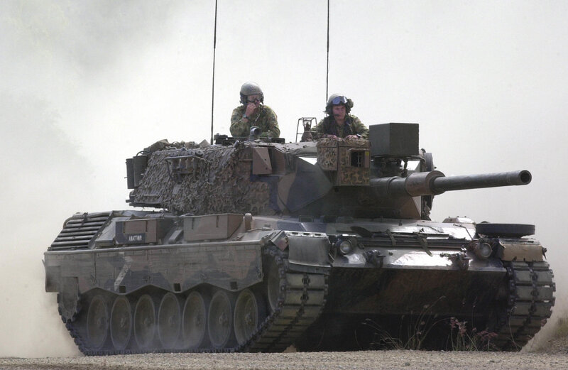Tank with soldiers in combat