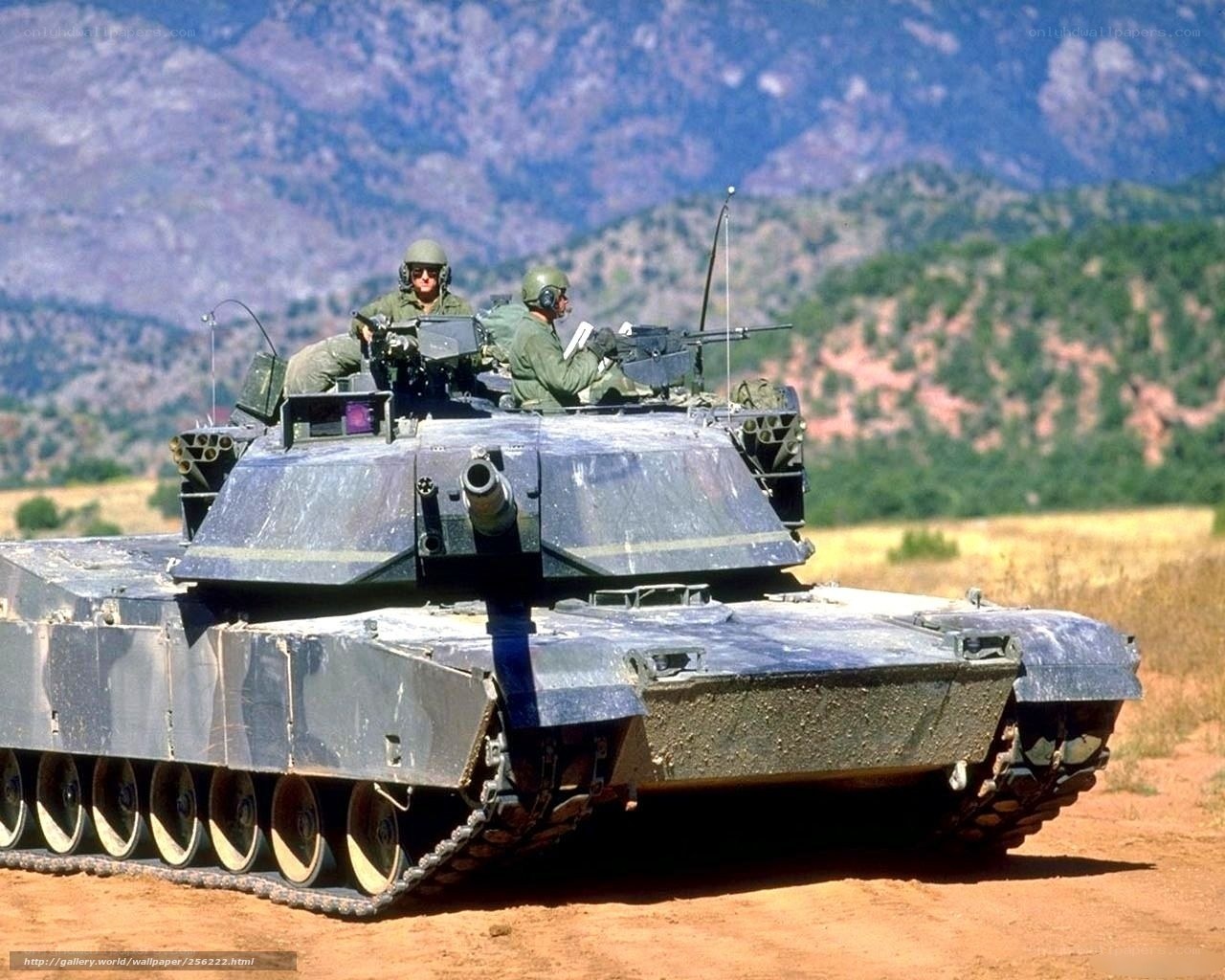 Tank with soldiers in field