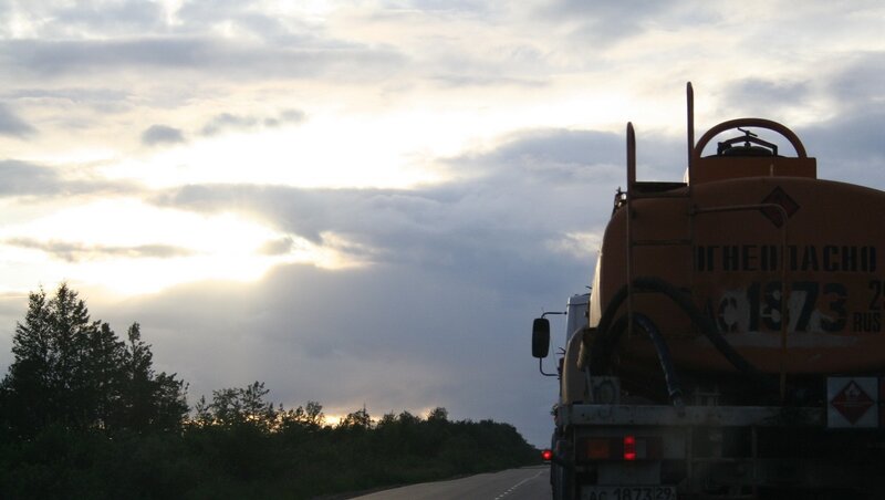 Tanker truck on a road at sunset