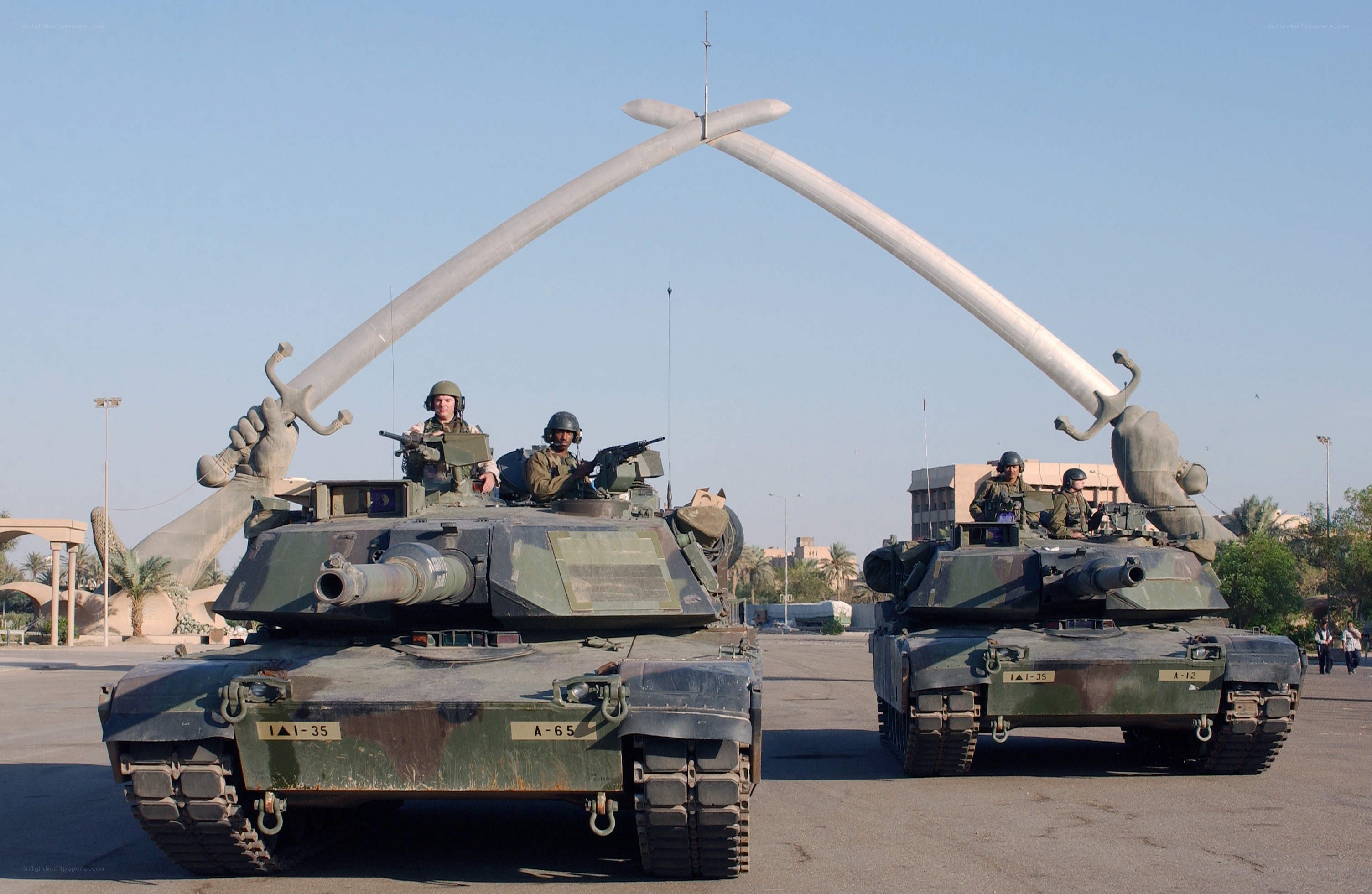 Tanks at a monument with swords