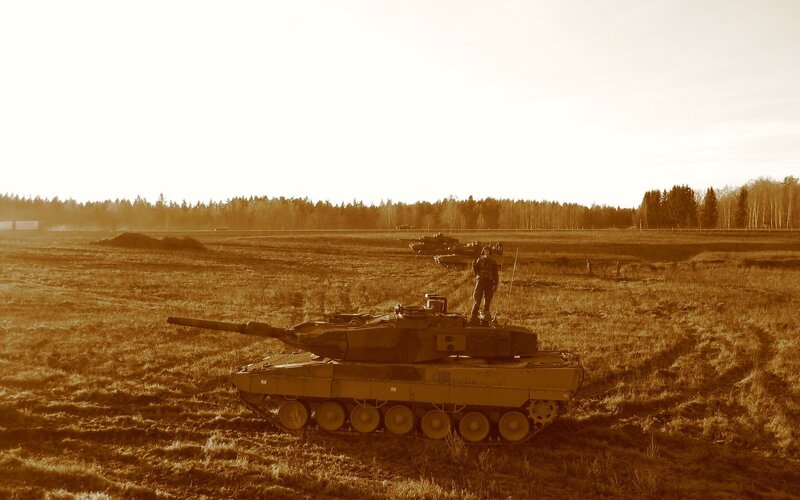 Tanks in a field at sunset
