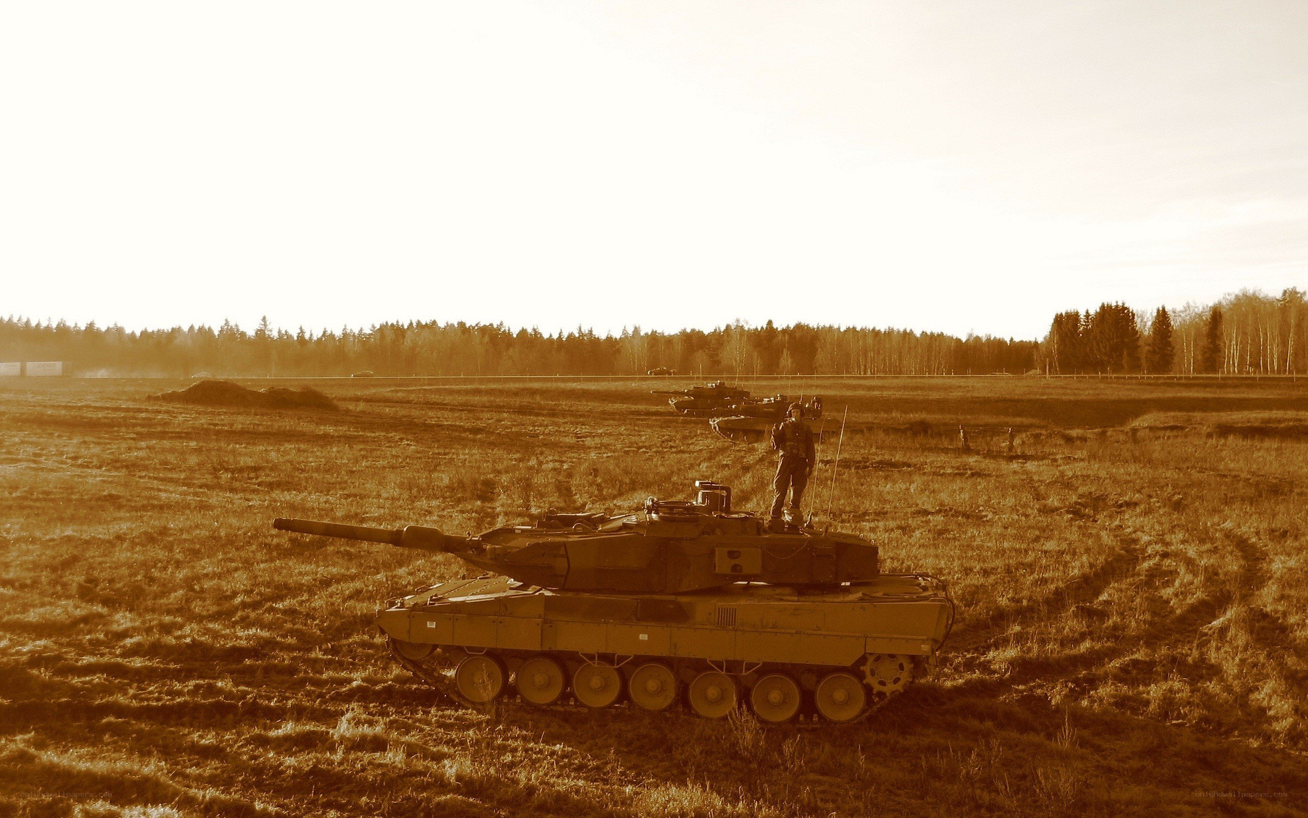 Tanks in a field at sunset