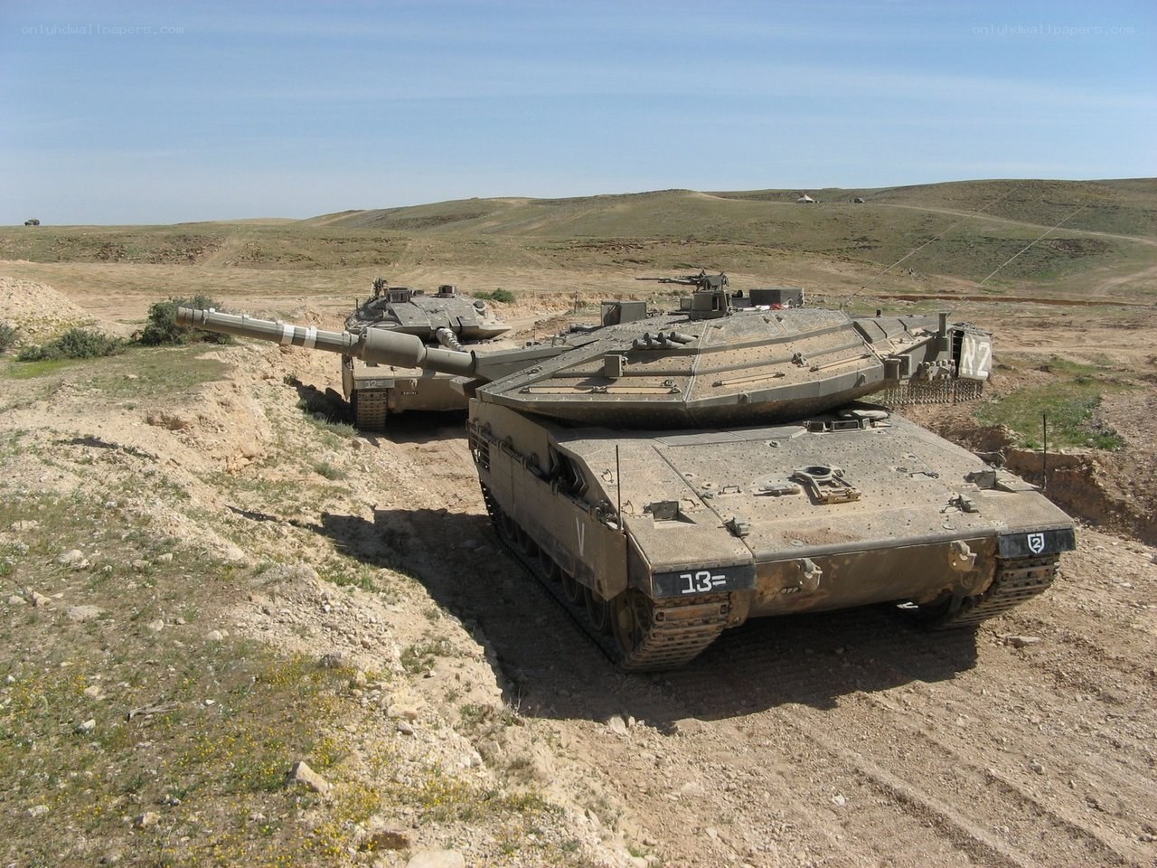 Tanks in desert terrain