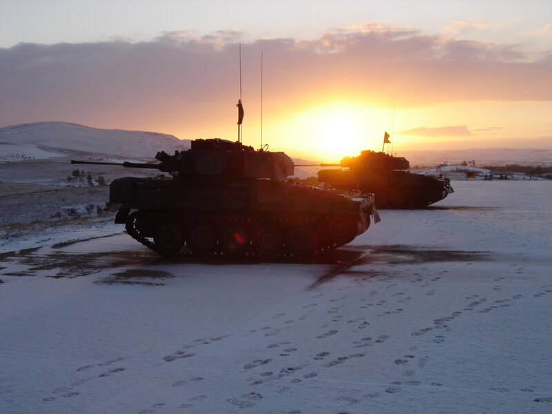 Tanks in snowy landscape at sunset