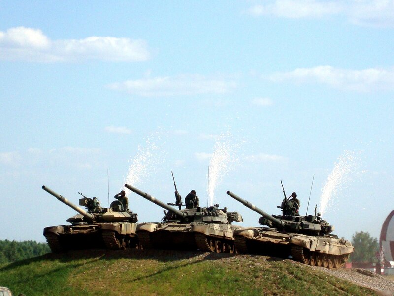 Tanks on a hill with water spray