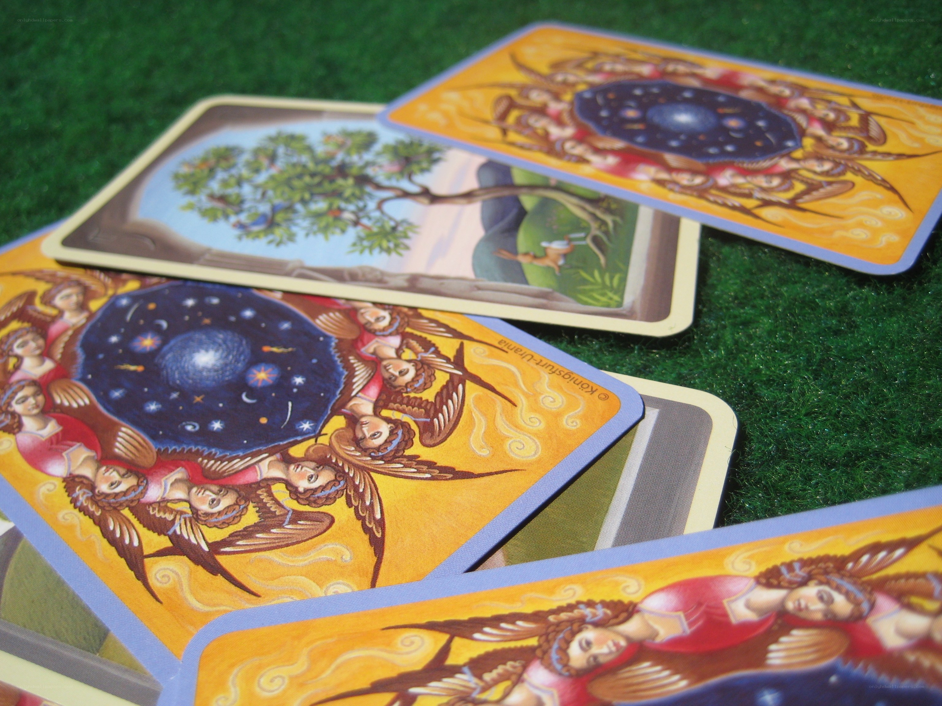 Tarot cards on green surface