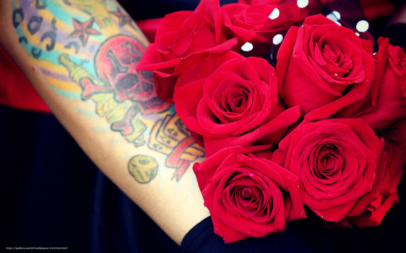tattooed arm holding roses