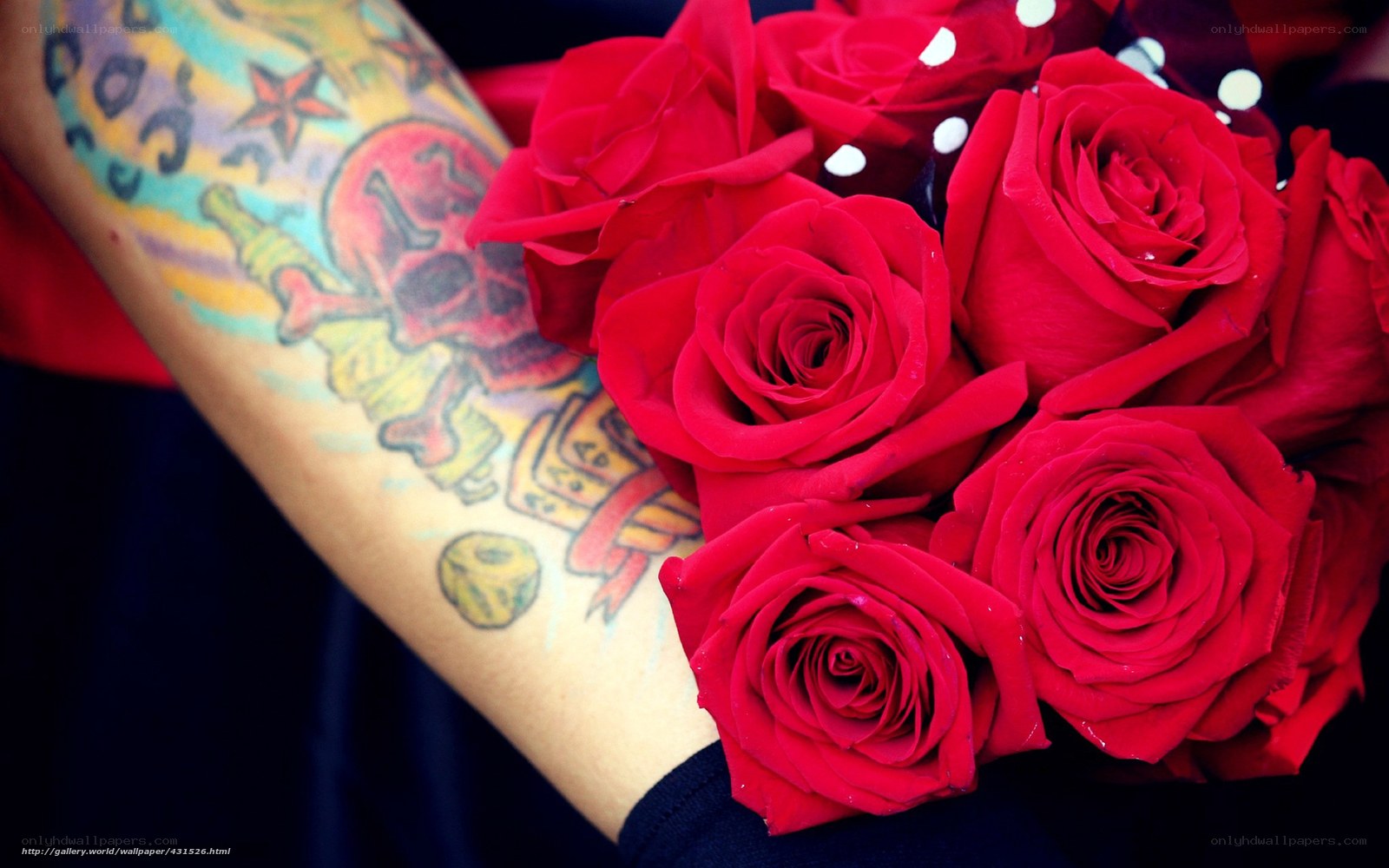 tattooed arm holding roses