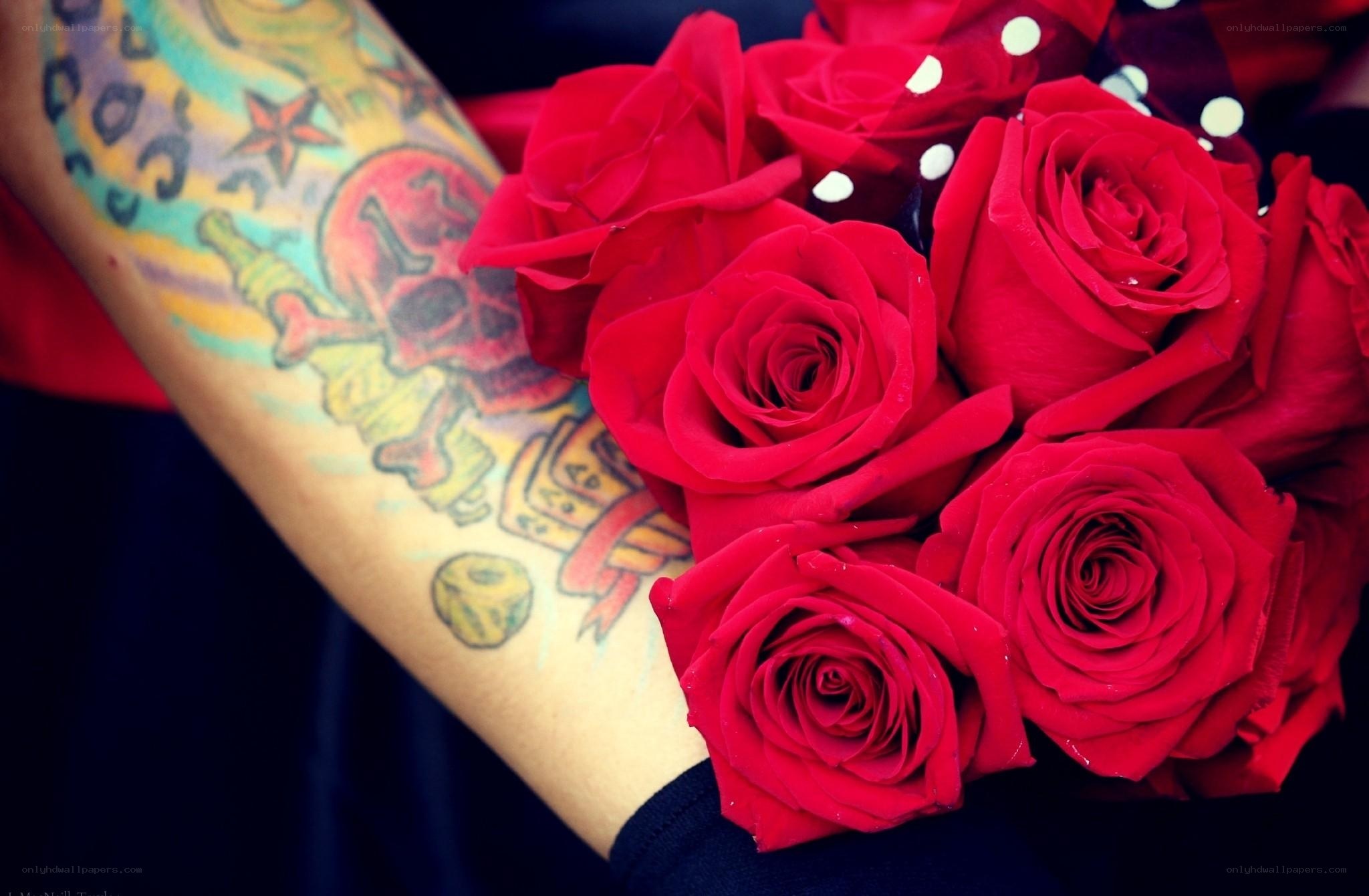 tattooed arm holding roses