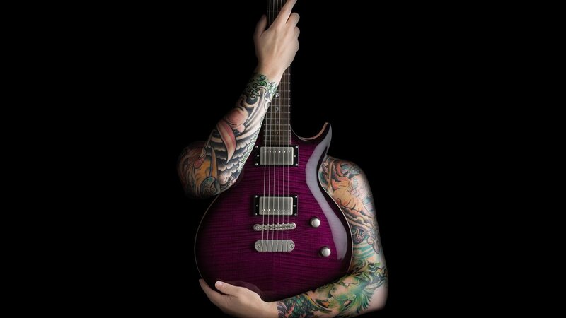 tattooed guitarist with purple guitar