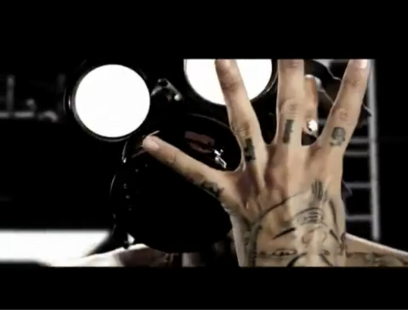 tattooed hand holding camera