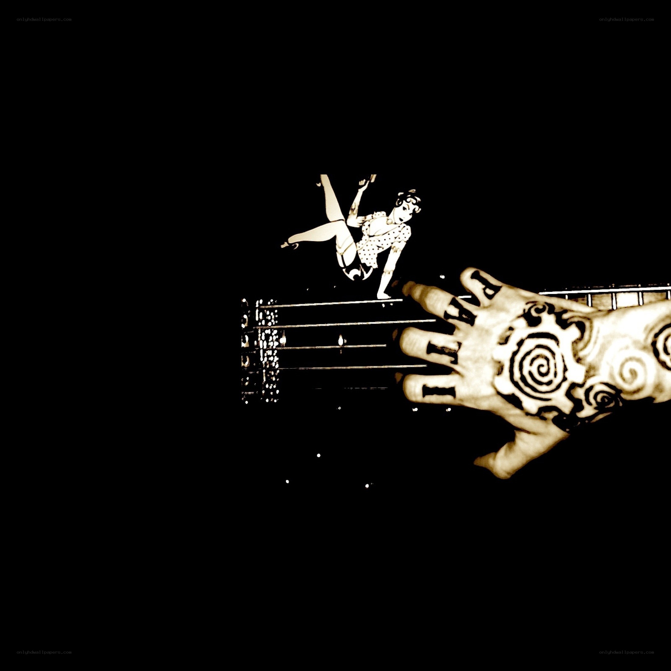 tattooed hand on guitar