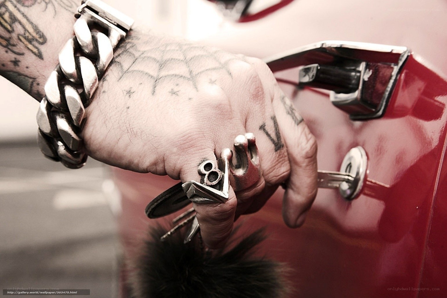 tattooed hand with car keys