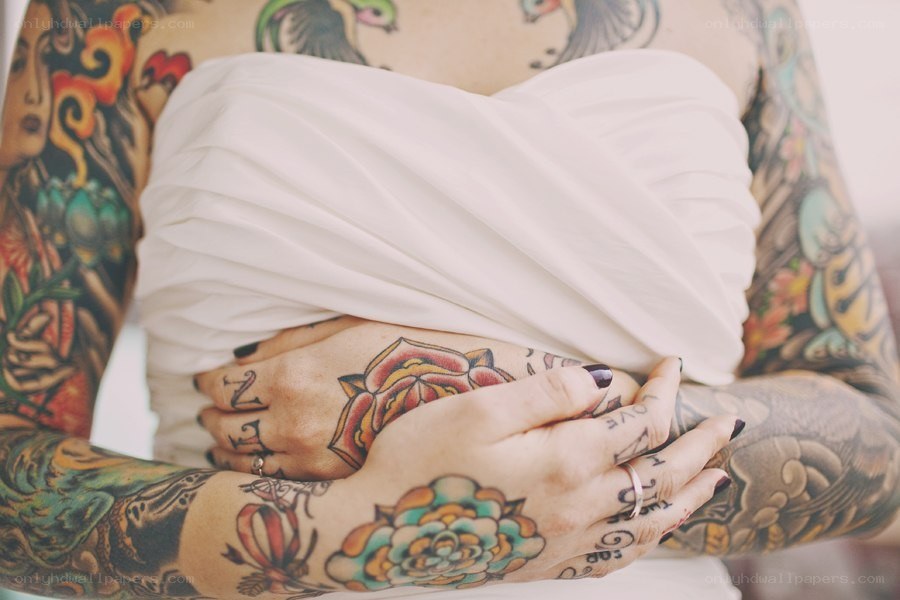 tattooed hands holding fabric