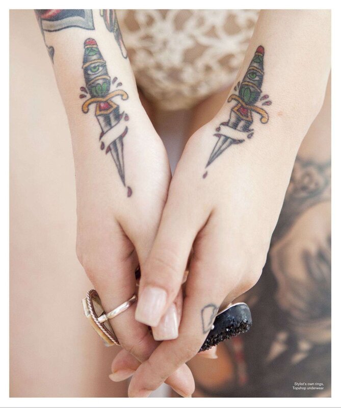 tattooed hands holding