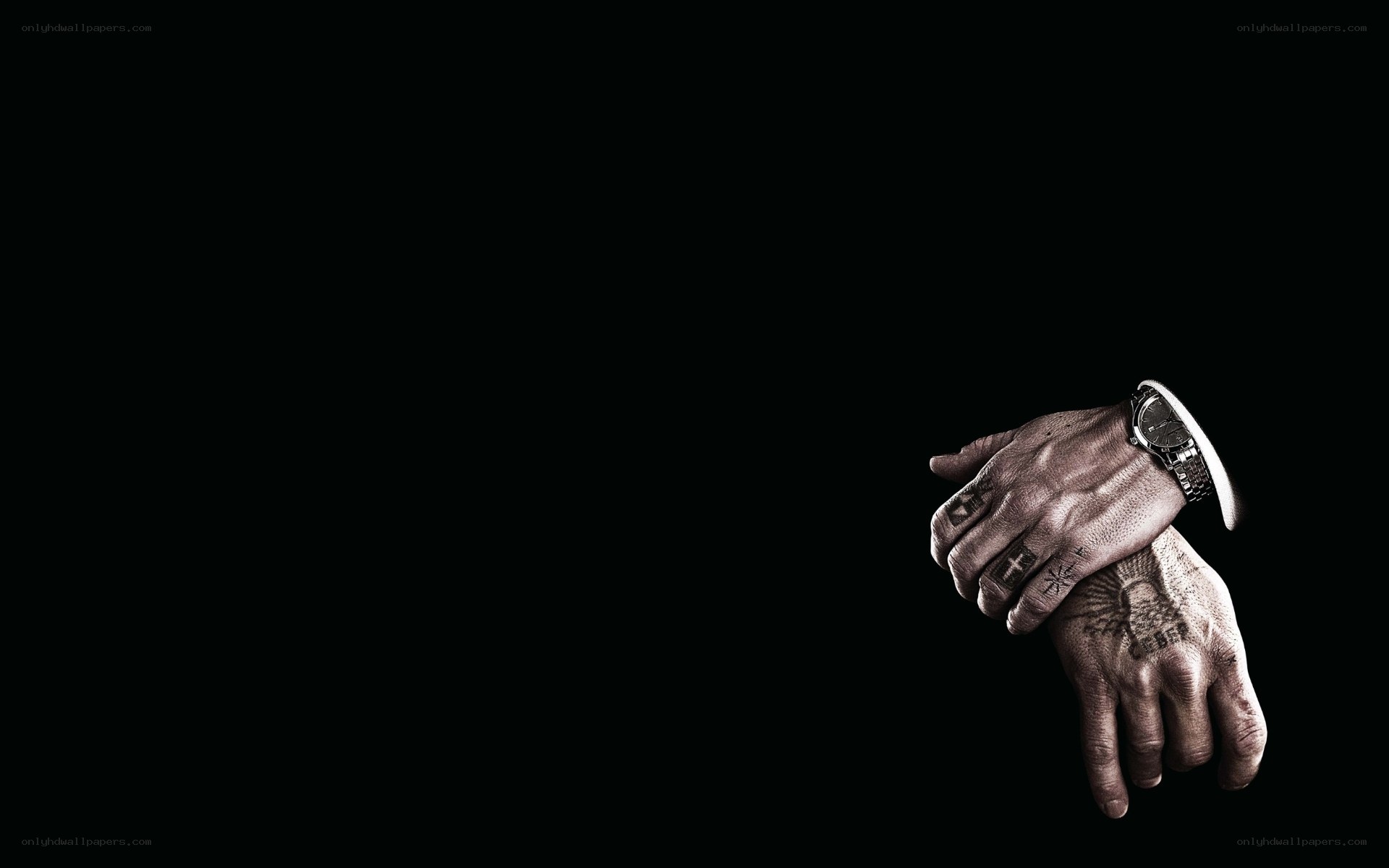 tattooed hands on black