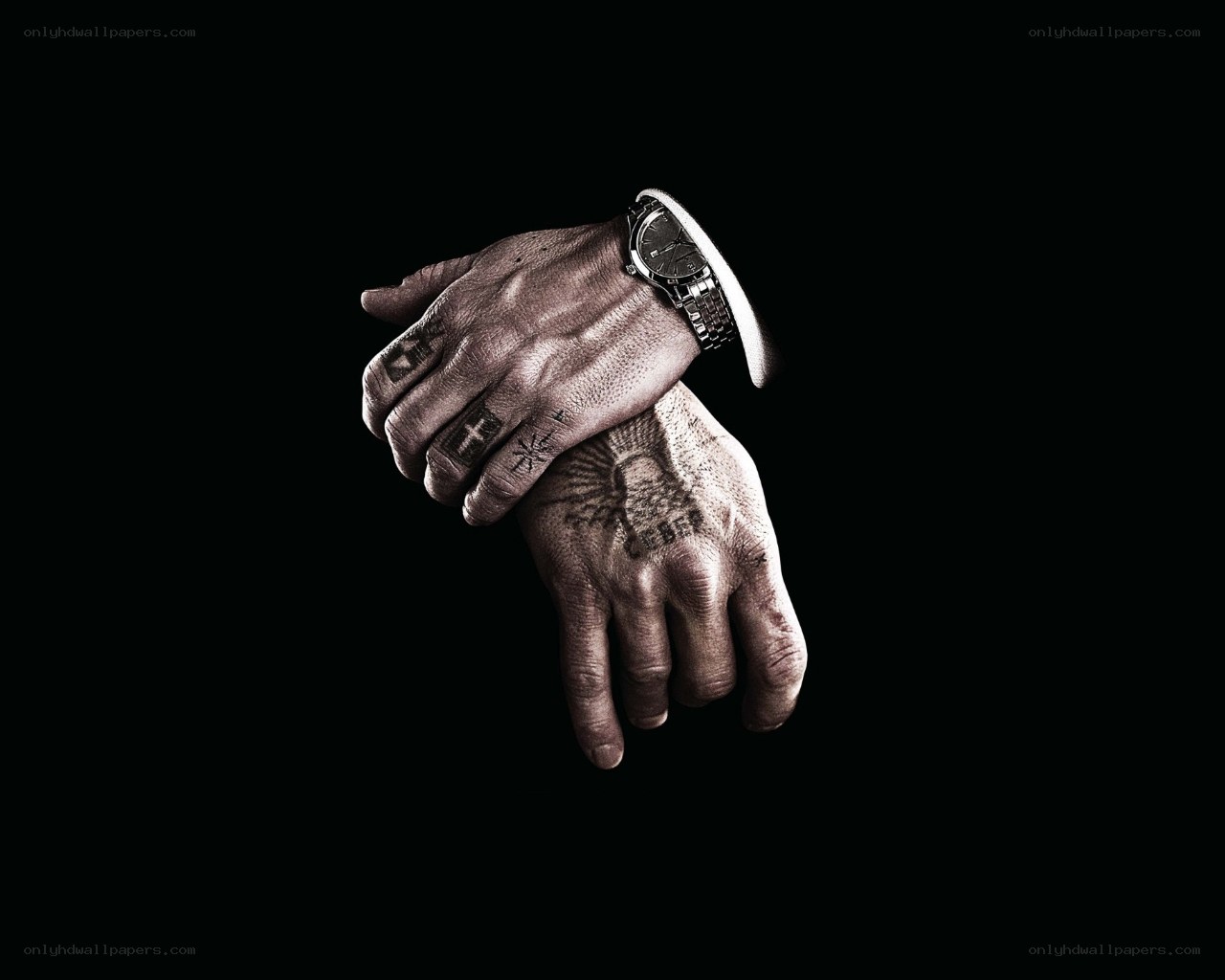 tattooed hands with watch
