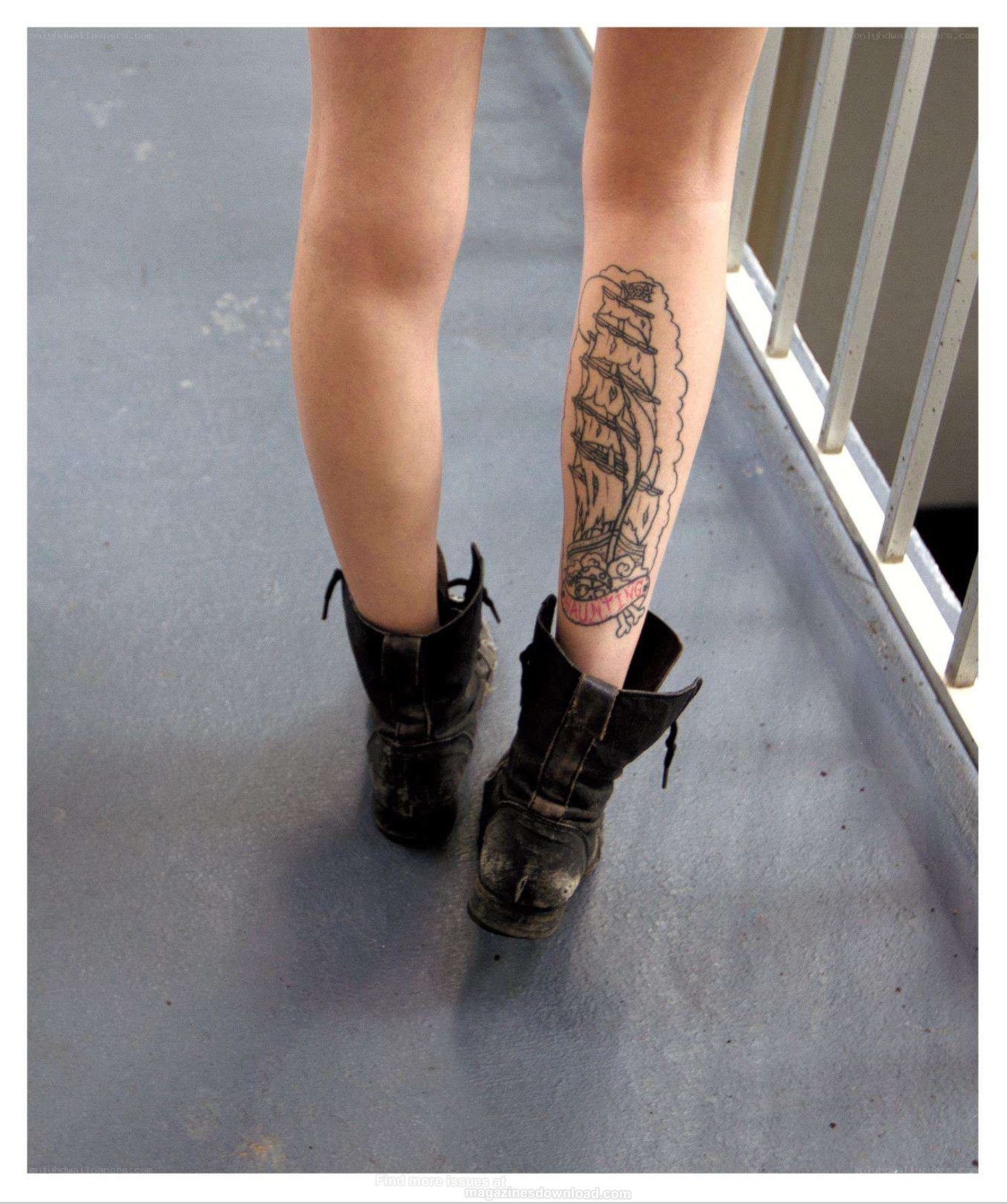 tattooed leg in boots