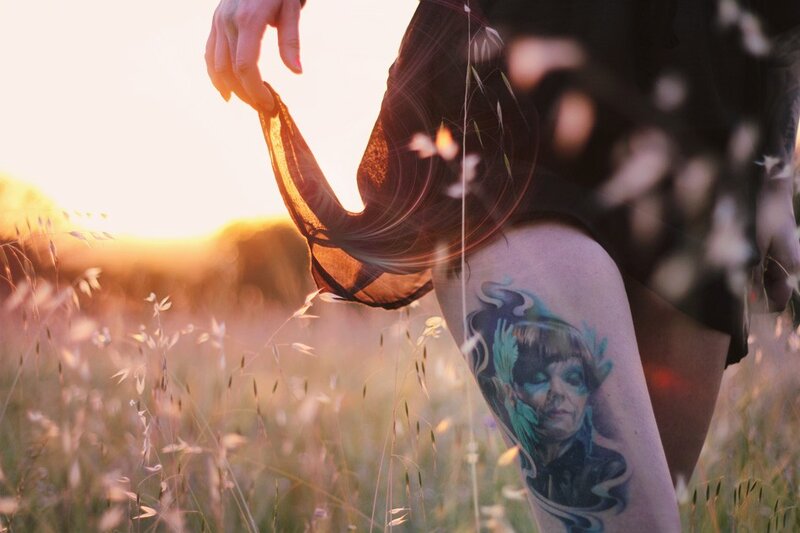 tattooed leg in field