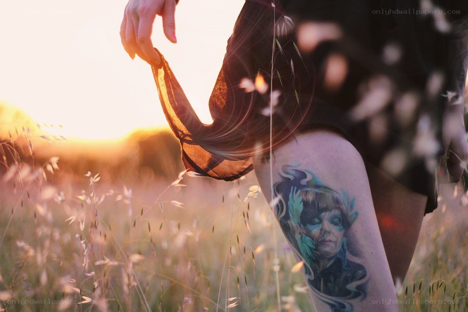 tattooed leg in field