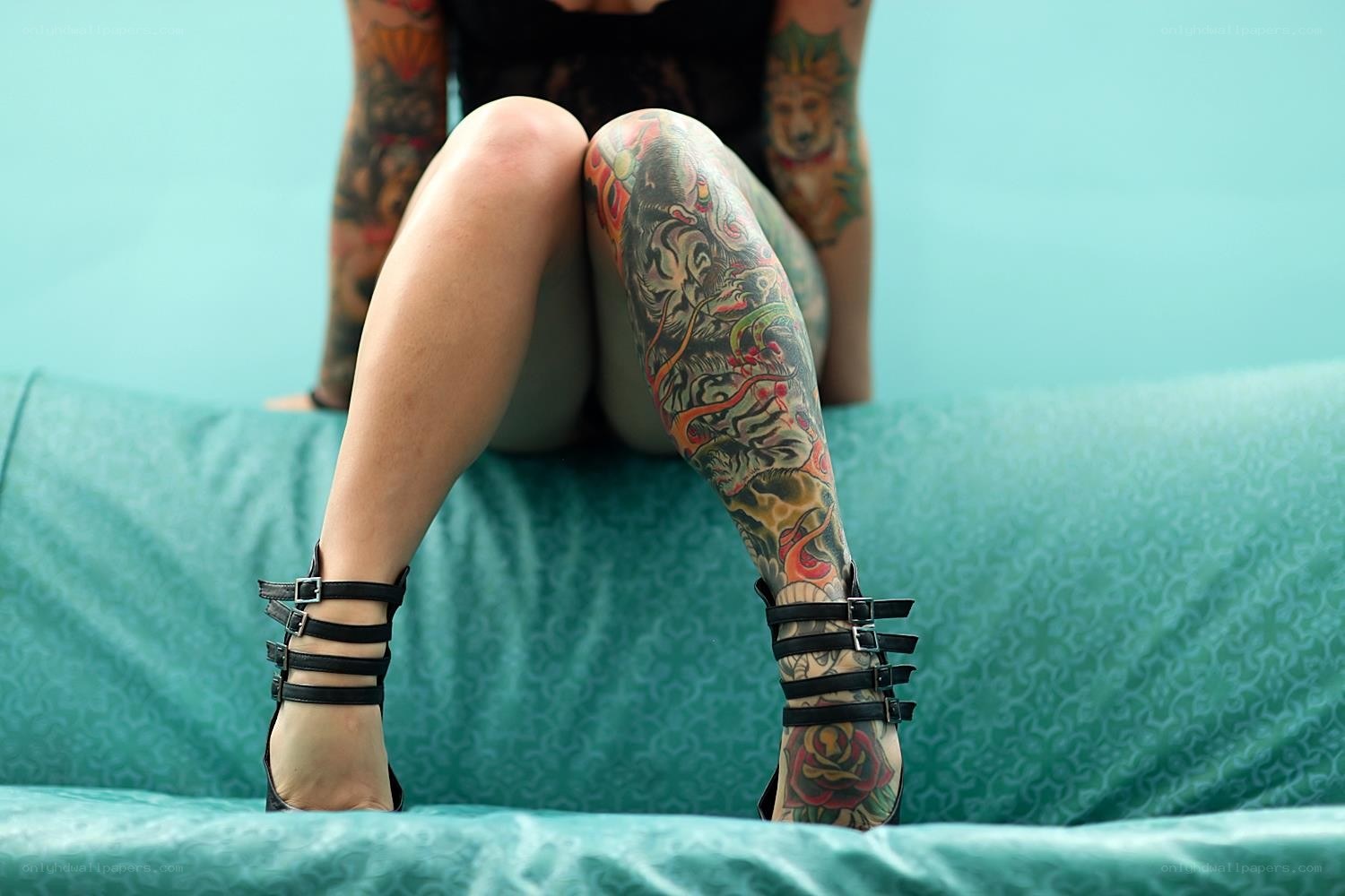 tattooed legs on couch
