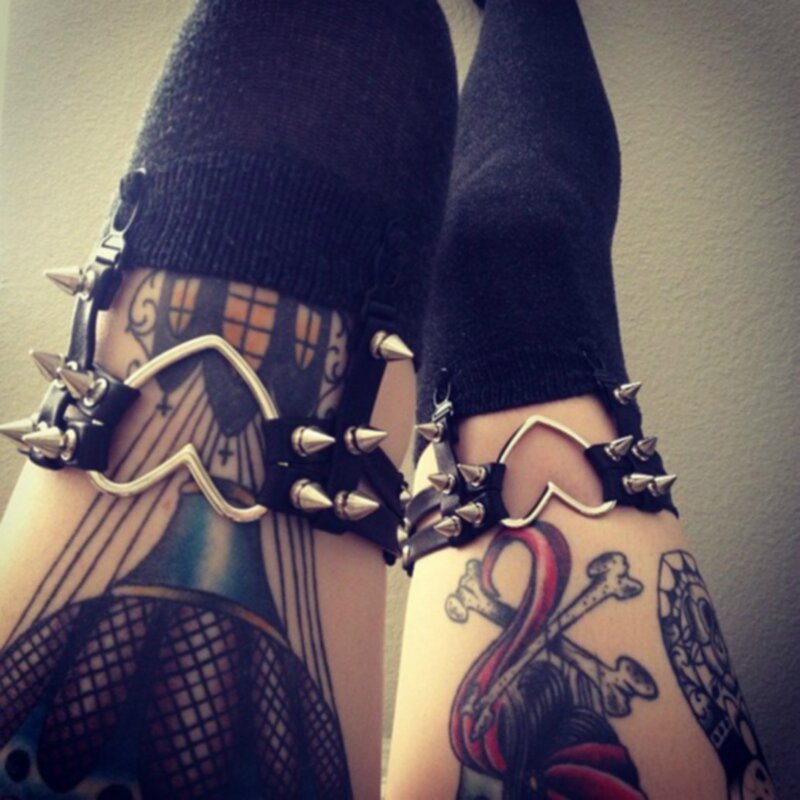 tattooed legs with spiked garters