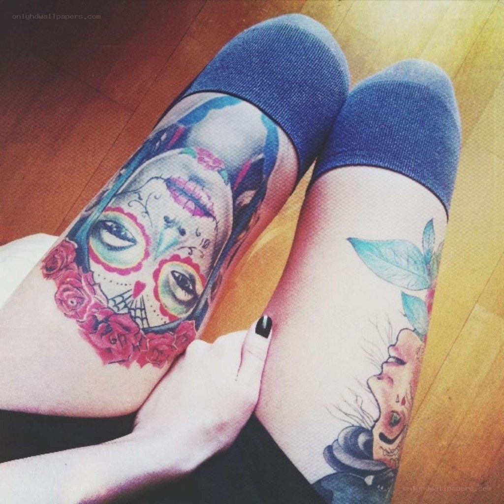 tattooed legs with sugar skull