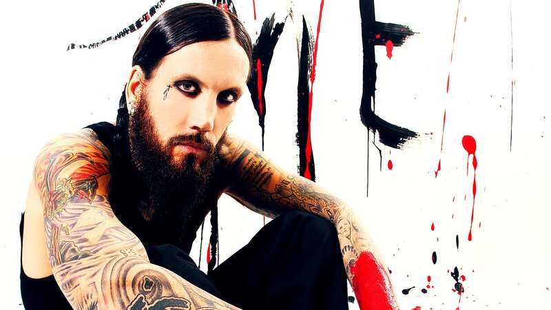 tattooed man with dark makeup