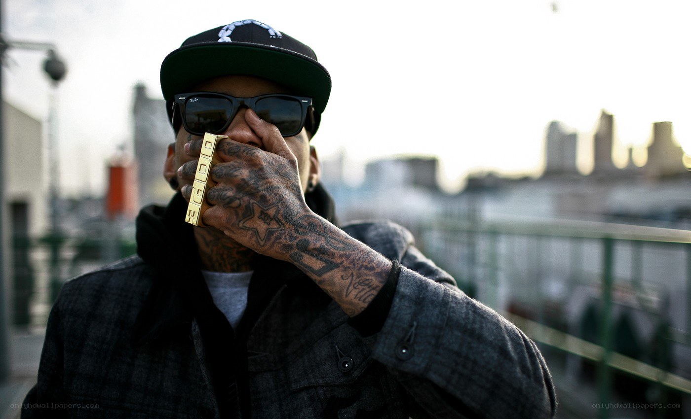 tattooed man with gold ring