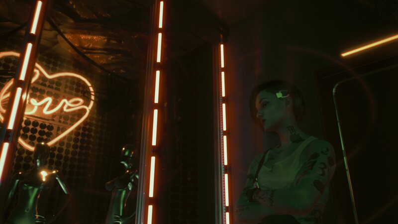 Tattooed Person in Neon Room
