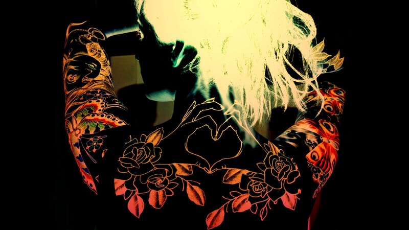 tattooed person with glowing hair