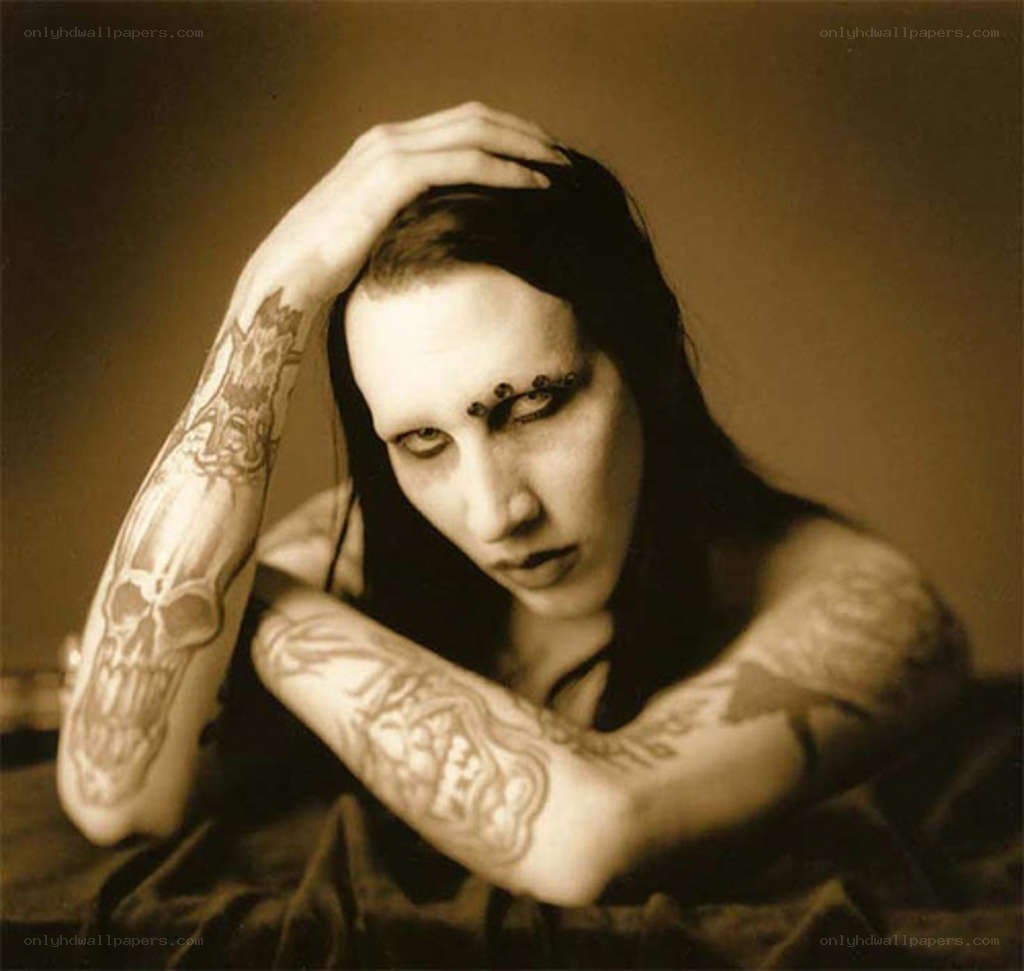 tattooed person with pale makeup