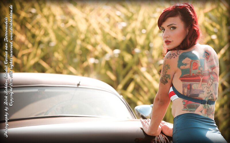 tattooed woman by classic car