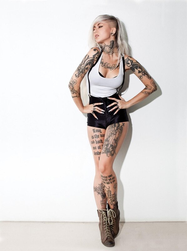 tattooed woman in black shorts