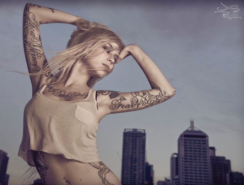 tattooed woman in city