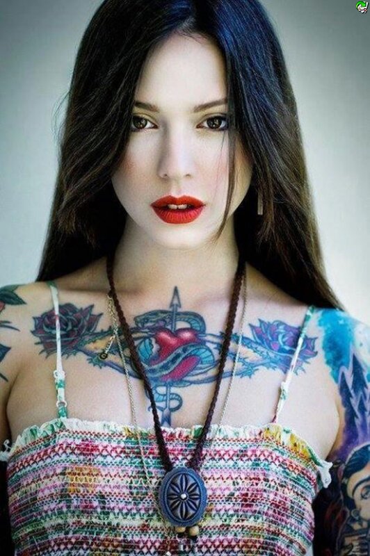 tattooed woman in colorful top