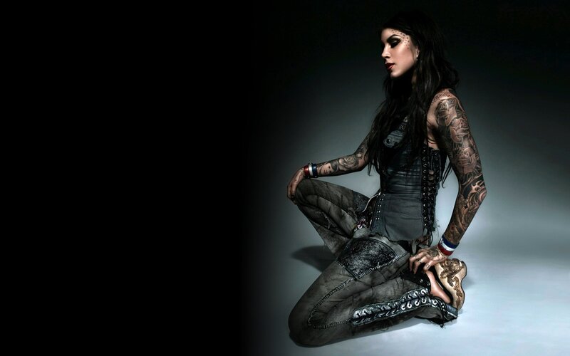 tattooed woman in dark attire