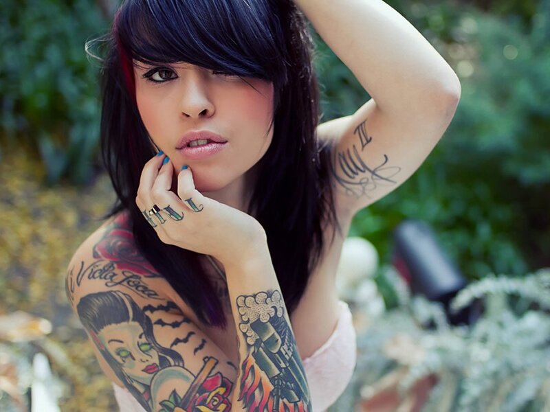 tattooed woman in garden