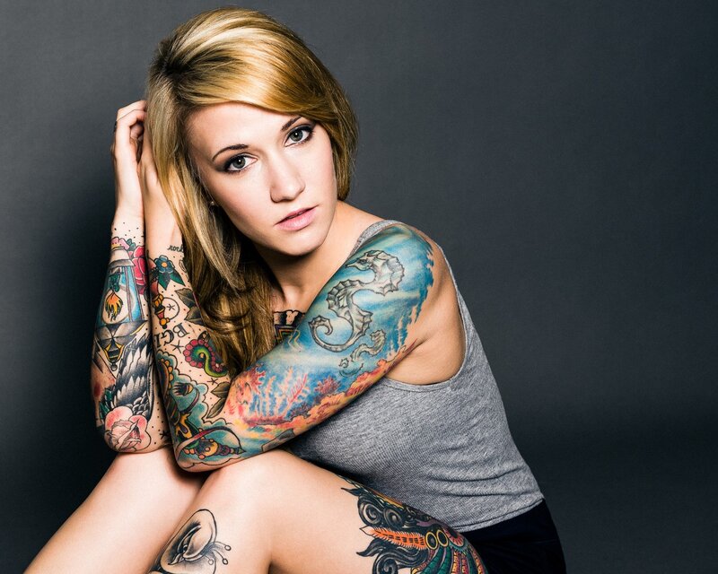 tattooed woman in gray tank top