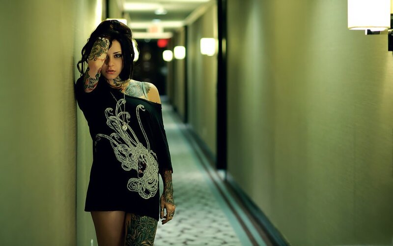 tattooed woman in hallway