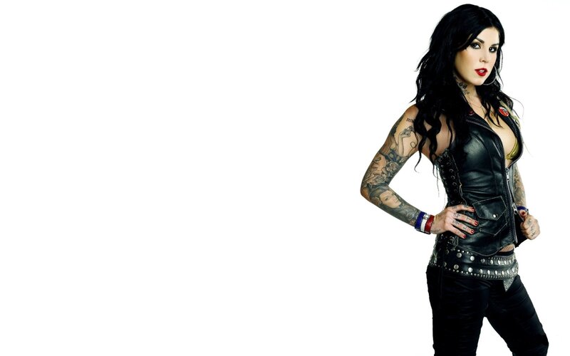 tattooed woman in leather vest