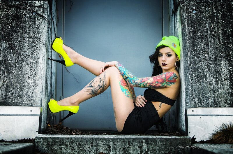 tattooed woman in neon heels