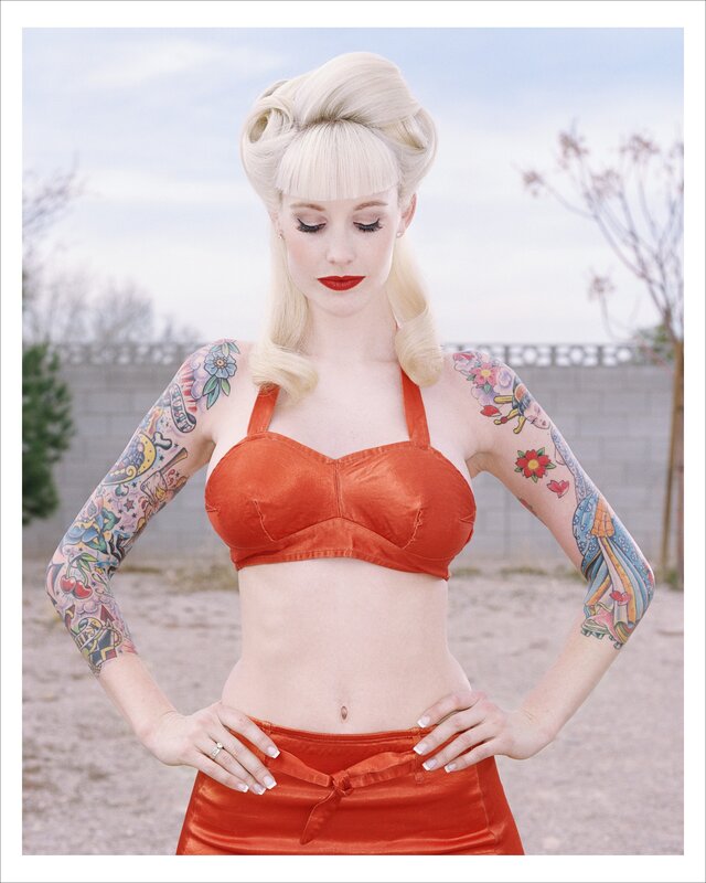 tattooed woman in red outfit