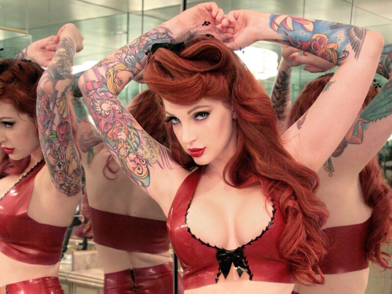 tattooed woman in red outfit