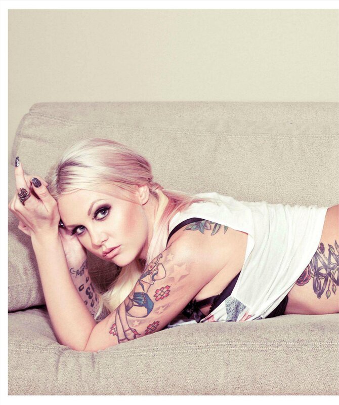 tattooed woman on couch
