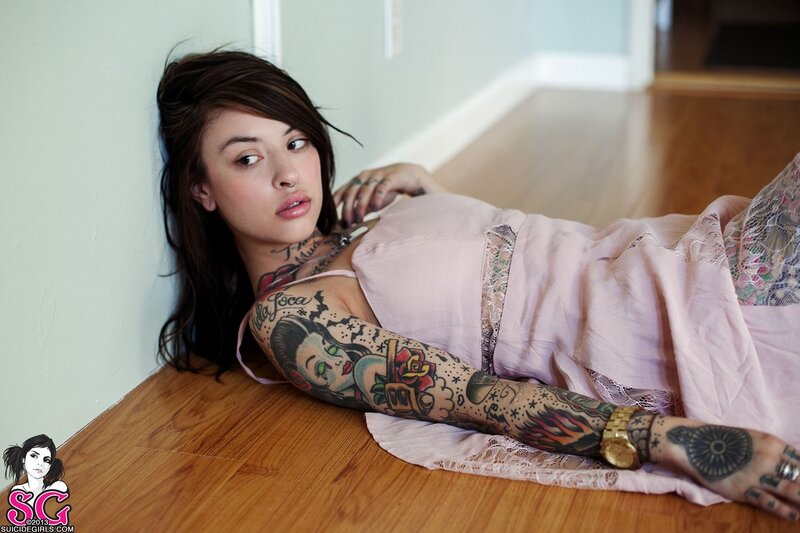 tattooed woman on floor