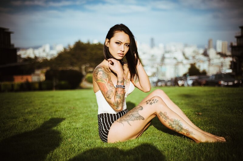 tattooed woman on grass