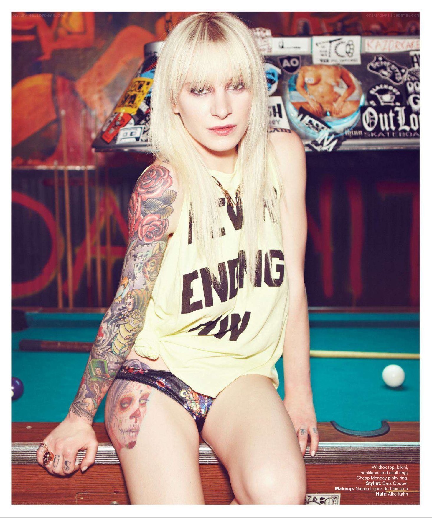 tattooed woman on pool table